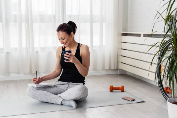 Young woman writing in her notebook Personal growth resolutions