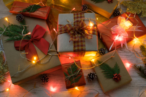 istock Christmas gifts wrapped in original form and colored lights 1356448474