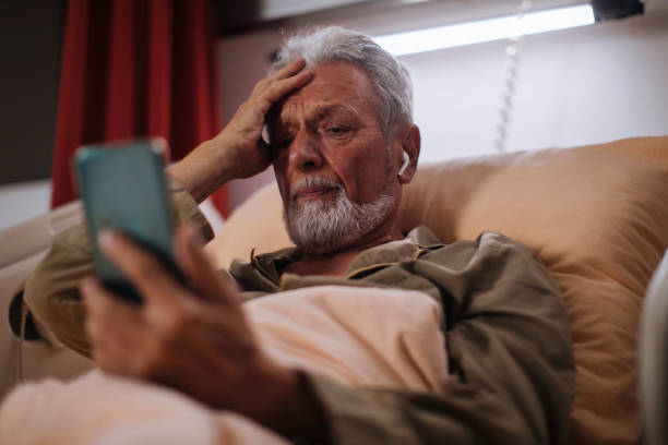 istock Using his phone in the hospital 1356449422