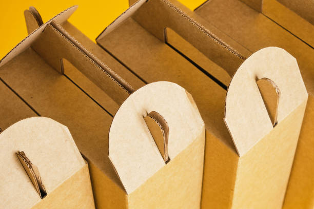 istock several cardboard boxes on a yellow background, boxes for a gift or product delivery without a logo 1356449892