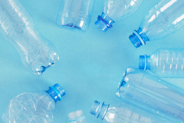 istock several plastic bottles on blue background. zero waste, pollution of nature, eco friendly concept. 1356449915