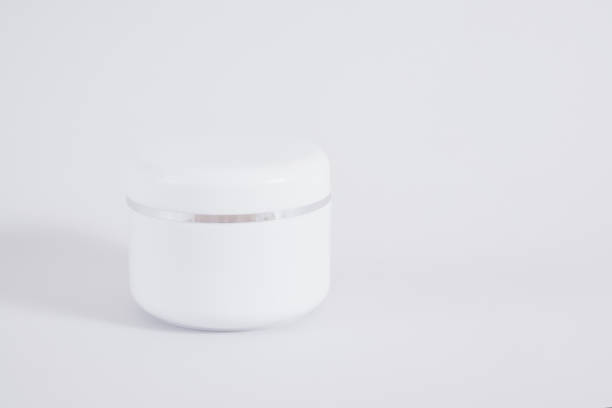 istock Blank cream jar on gray background mock up 1356450541