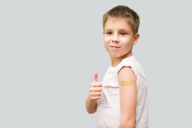 istock A satisfied boy with a plaster on his hand after vaccination shows a thumbs up gesture. 1356454156