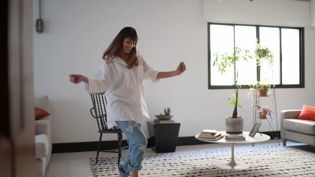 Young woman dancing at home