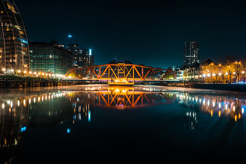 View of an illuminated footbridge in Salford quays during night in Manchester