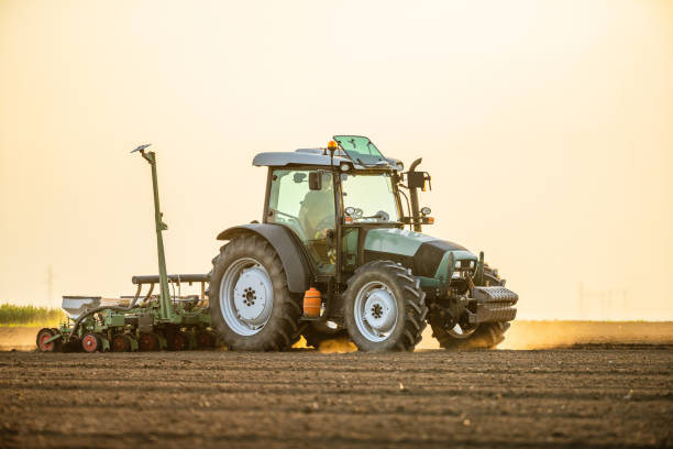 istock Tractor drilling seeding crops at farm field. Agricultural activity. 1356457799
