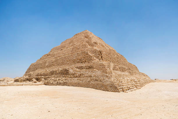 great step pyramid of djoser, saqqara. ruins in front of pyramid, blue sky. - the step pyramid of zoser imagens e fotografias de stock