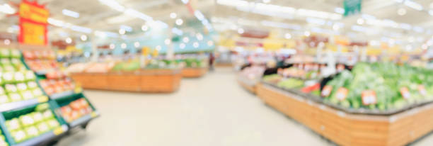 supermarket grocery store interior aisle abstract blurred background - supermarket imagens e fotografias de stock