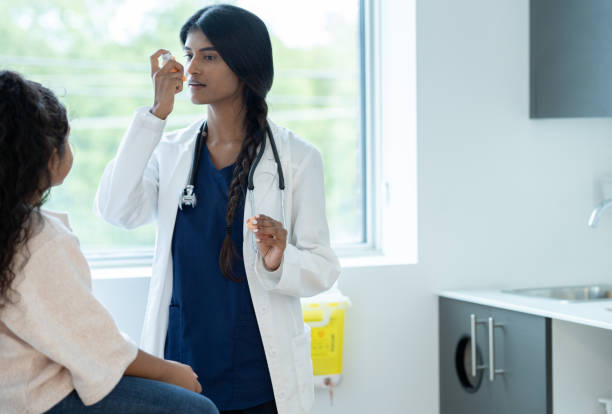 Doctor Instructing a Young Patient on Proper Inhaler Usage
