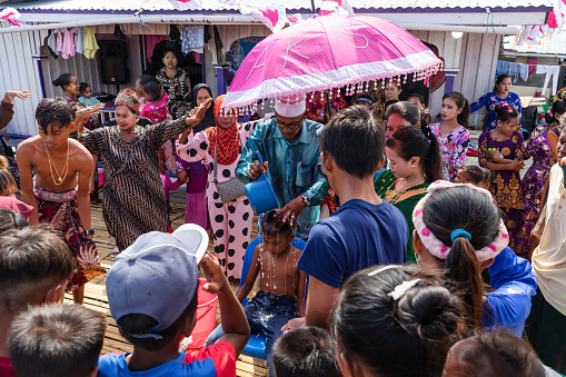 OMADAL, MALAYSIA, Nov 11, 2021: Residents in the water village of Pulau Omadal are celebrating one of the young men who will be circumcised in a special lively traditional ceremony.