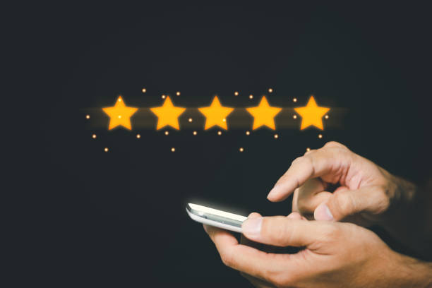 istock customers using smartphones There are five virtual stars with glowing lights, for rating customer satisfaction assessments, product and service ideas. 1356465308