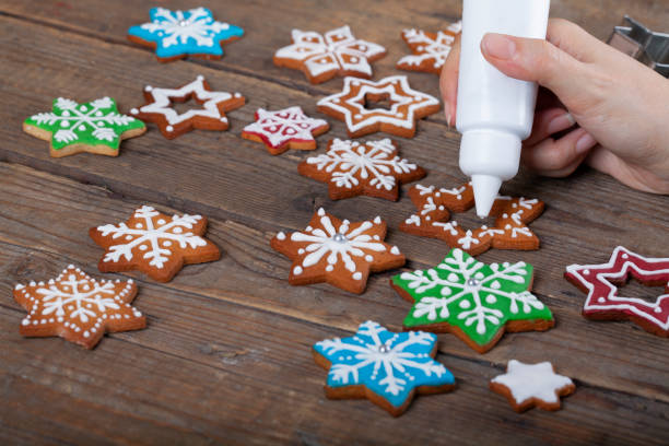 istock Decorating Star shaped Christmas gingerbread cookies with white icing 1356466577