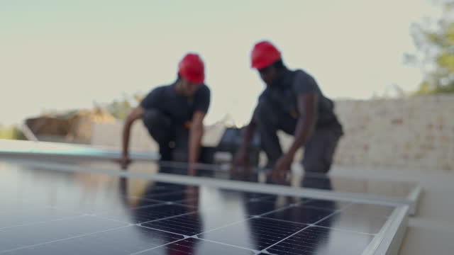 Colleagues installing the solar panels
