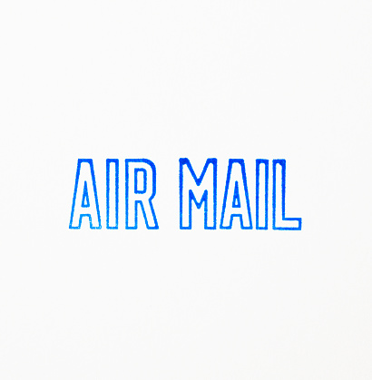 Close-up of “AIR MAIL” rubber stamp, isolated on white background.