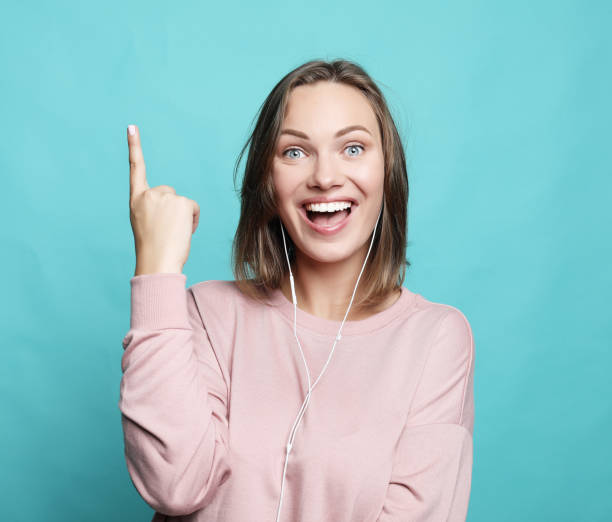 istock Surprised funny woman showing empty copy space with her finge 1356484224