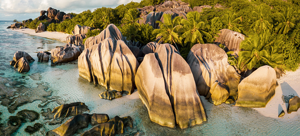 La Digue Anse Source d'Argent Beach. Drone Point of view over the famous Anse Source d'Argent Beach with it’s famous granite boulder rock formations and crystal clear ocean on La Digue Island. Stiched XXL Panorama in warm sunset light. Anse Source d'Argent is under the best-known beaches in the Seychelles. La Digue Island, Seychelles Islands, East Africa