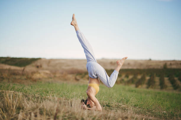 istock Cute girl training on a sky backgroung in a field 1356487513