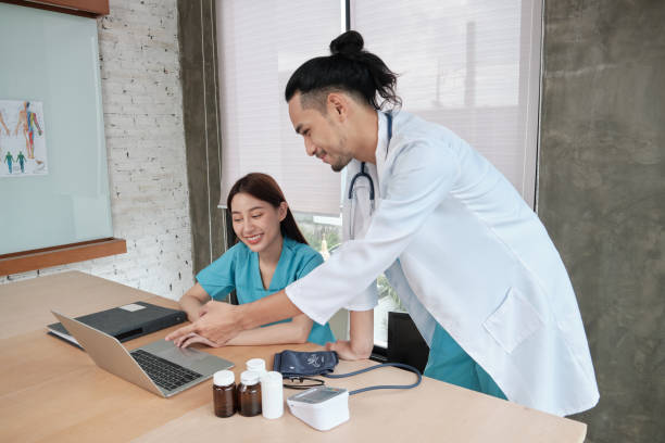 istock Two uniformed young doctors work in medical clinic office. 1356489563