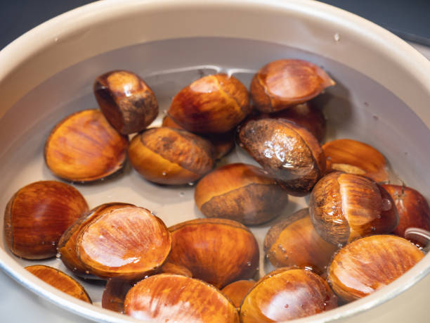 chestnuts with the taste of autumn. boiled chestnuts. - castanhas imagens e fotografias de stock