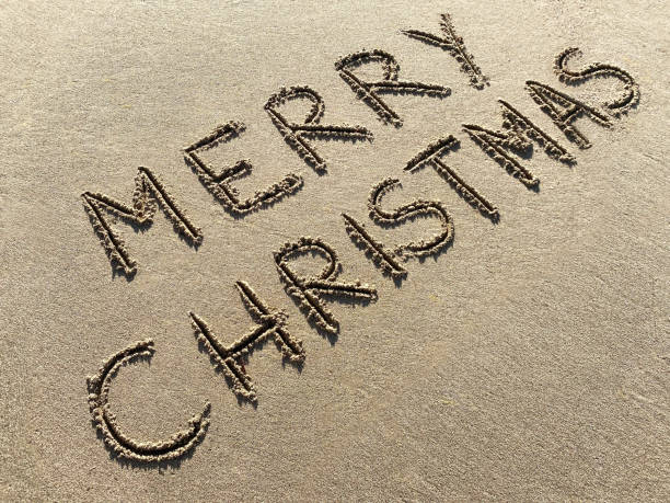 istock Merry Christmas, lettering on the beach 1356494130