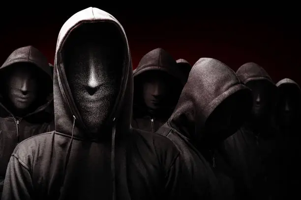 Group of criminal man in a hidden mask on black background