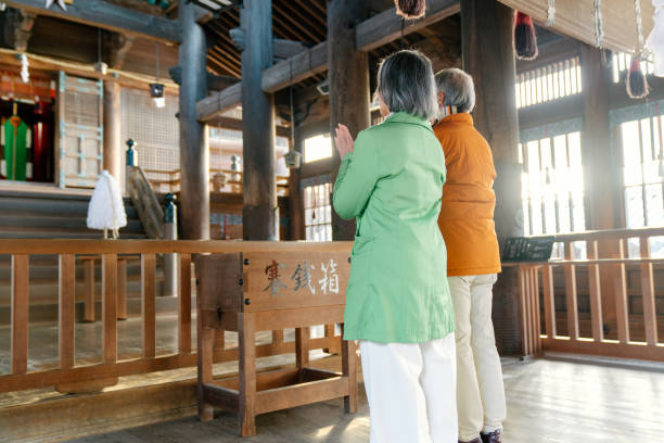 istock Senior couple praying a Japanese temple for Hatsumode 1356496480