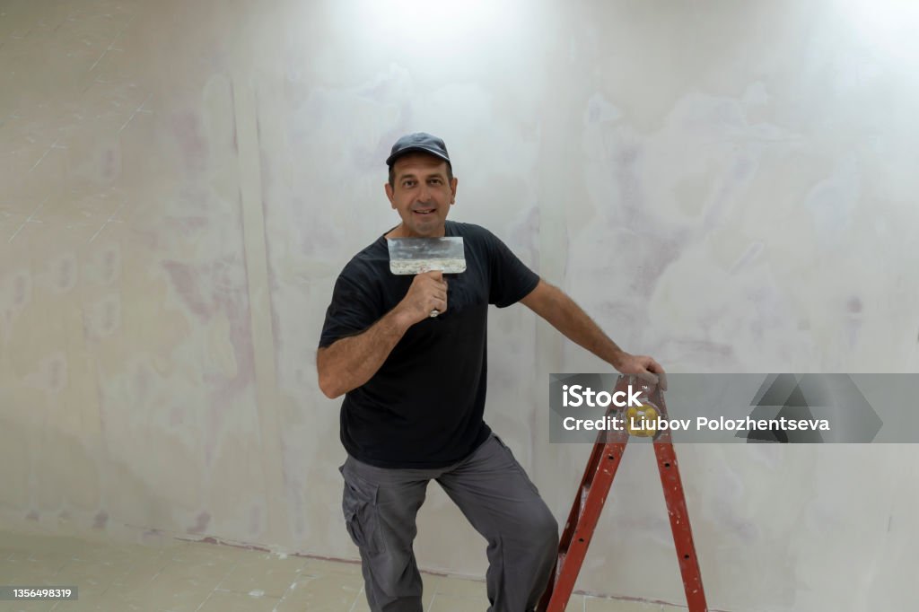 Master Plasterer Male Builder Master Office Plasterer With A Tool In Working Clothes ...