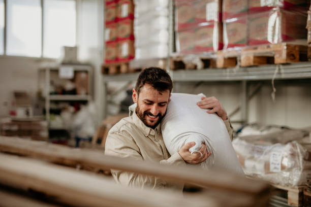 istock Cheerful warehouse worker￼ carrying a bag 1356501292