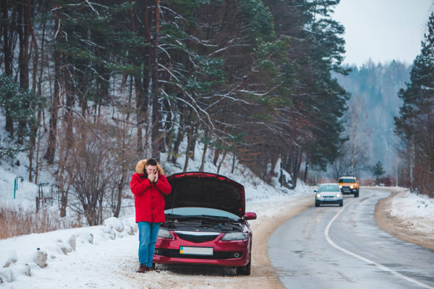 istock man standing near broken car with opened hood calling help 1356502590