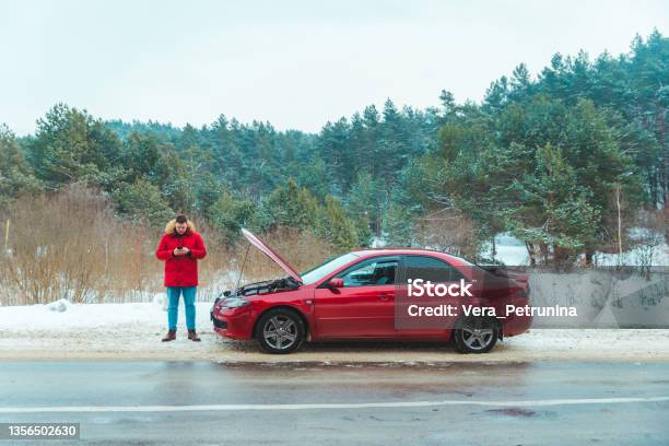 Man Standing Near Broken Car At Roadside Snowed Winter Weather Stock Photo - Download Image Now