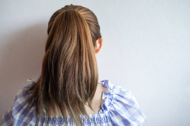 istock Young woman with ponytail hairstyle from behind. 1356503606
