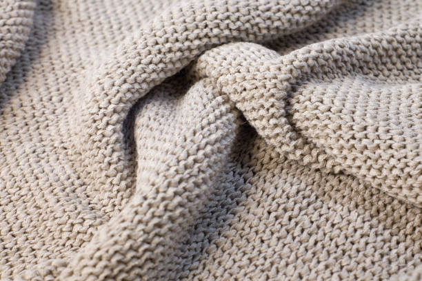 istock Soft light natural texture of knitted wool textile material background. White crochet cotton fabric woven canvas 1356504870