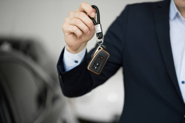 istock Car dealer with key close-up 1356505723