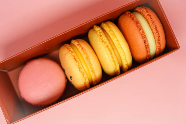 istock colored macarons in a burgundy box on a pink background. sweets as a gift. preparation for the celebration. fresh and delicious desserts. 1356507909