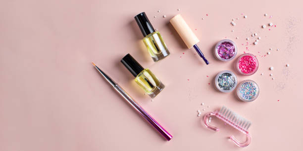 istock A set of sequins, varnishes, brushes for creating a festive manicure on a pink background. Copy space 1356509109