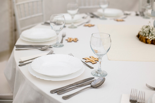 Round table with cutlery and plates at wedding