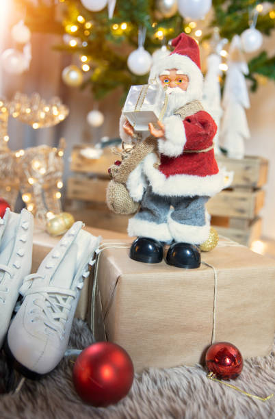 istock Santa claus figurine at christmas tree 1356509368