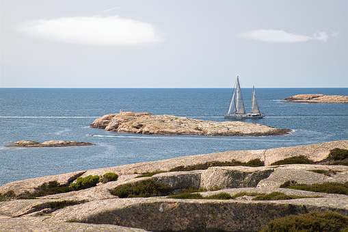 Sunny day, clear sky, boat or yacht on the sea. Some islands at the skerry coast of Västra götaland