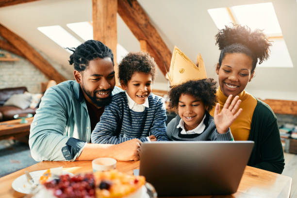 happy black family making video call during little girl's birthday at home. - child party group of people little girls imagens e fotografias de stock