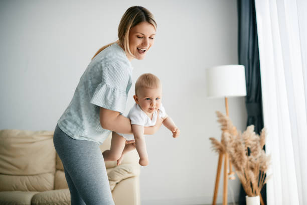istock Young playful mother having fun with her baby at home. 1356510529
