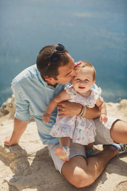 istock Dad kisses daughter 1356511811