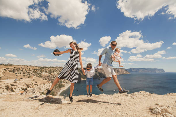 istock Happy family jumping up simultaneously 1356511854