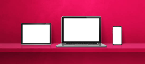 istock Laptop, mobile phone and digital tablet pc on pink wall shelf. Banner background 1356512822