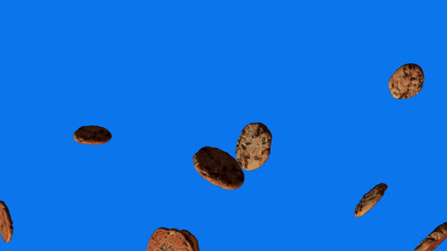 Christmas cookies are falling on a blue background.