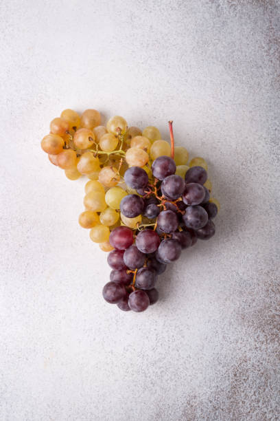 istock Grapes on a light background. Fresh fruit. Dieting and healthy eating. Copy space 1356515578