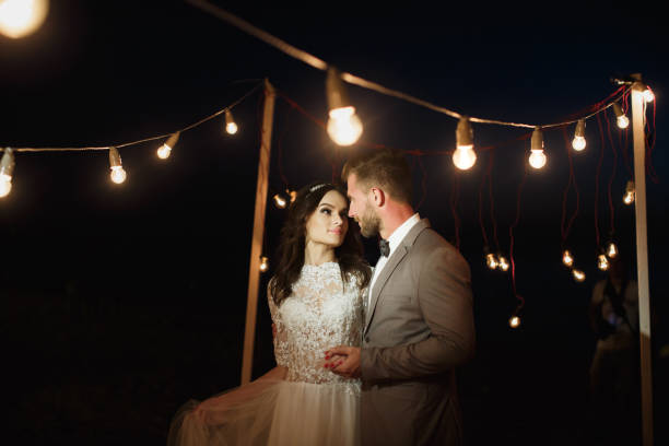 istock Night wedding ceremony. The bride and groom hugging. 1356515616