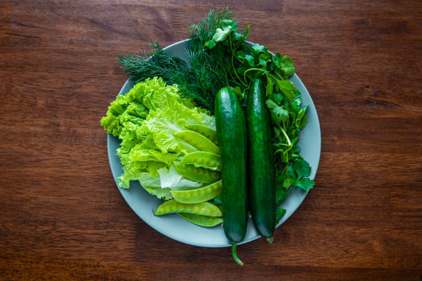 istock A simple appetizer with fresh cucumbers, lettuce, dill, cilantro and green peas on a plate on the wooden table. Spring salad, spring greens, healthy food from natural products. Vegetarian food 1356515793