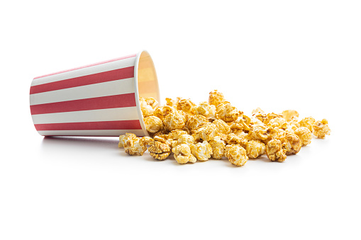 Sweet caramel popcorn in paper cup isolated on white background.