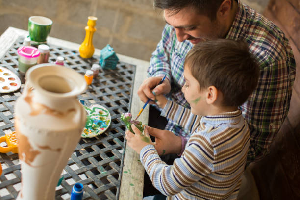 istock Father and son paint colors. 1356519341