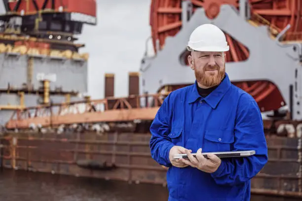 Photo of A male engineer at an oil and gas construction site